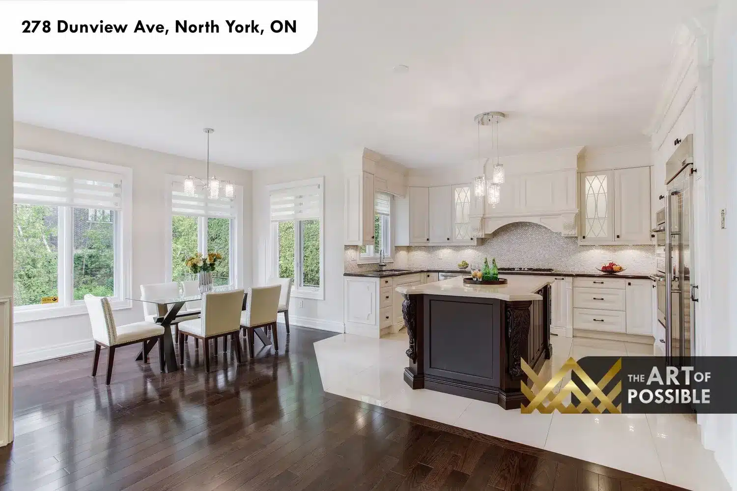 Kitchen open to breakfast area with garden windows and dark-stained island