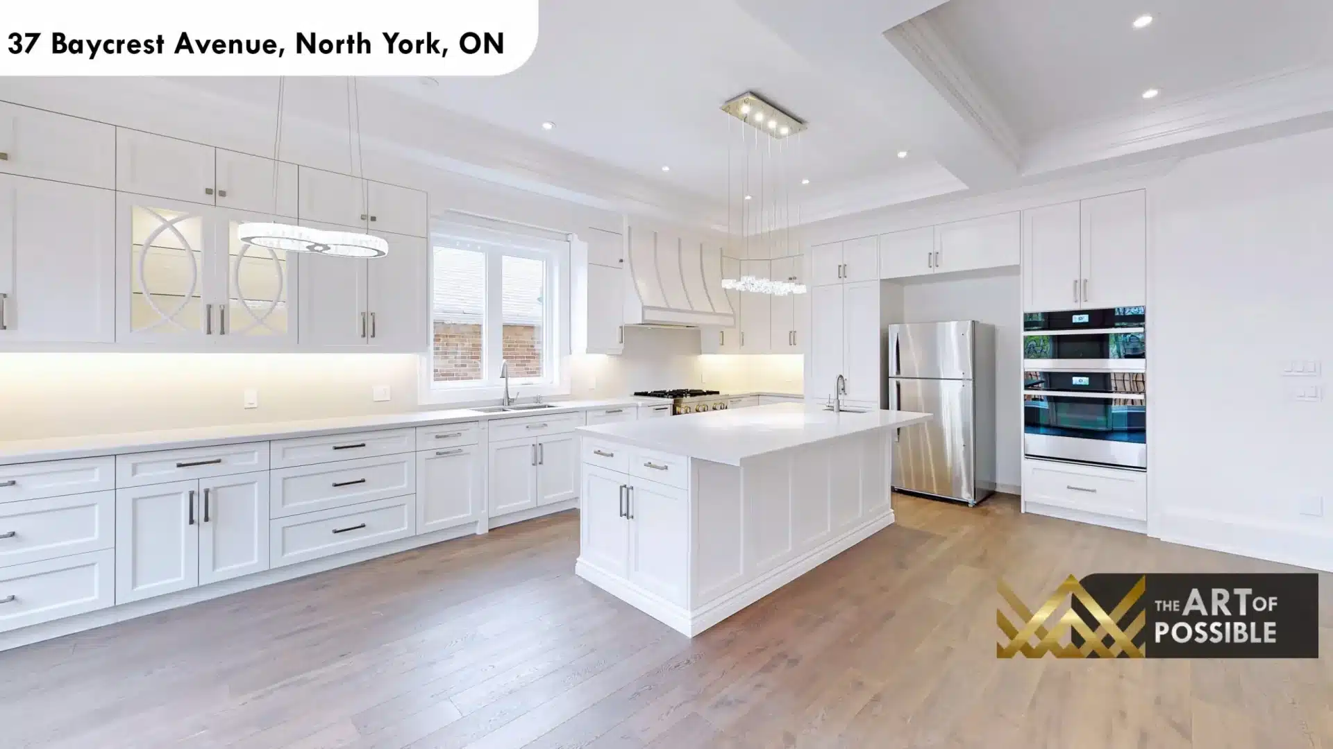 37 Baycrest Ave kitchen custom arch range hood brass gas range white cabinetry under cabinet lighting