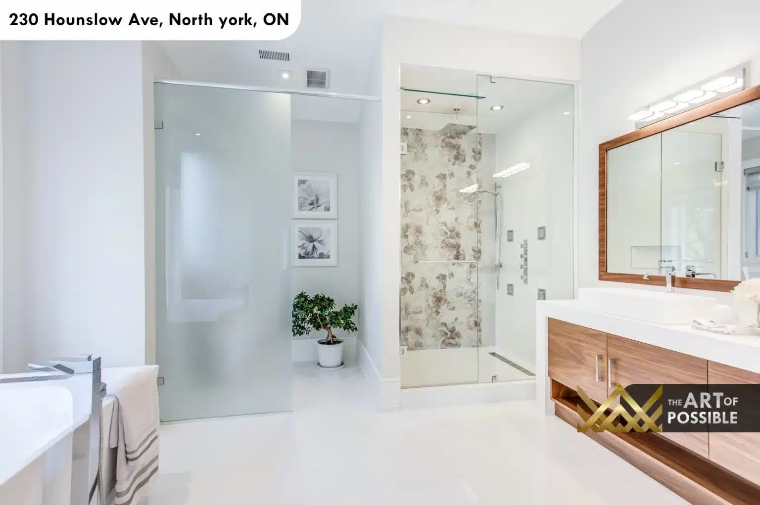 Ensuite vanity with walnut cabinetry, floral tile shower and chrome fixtures