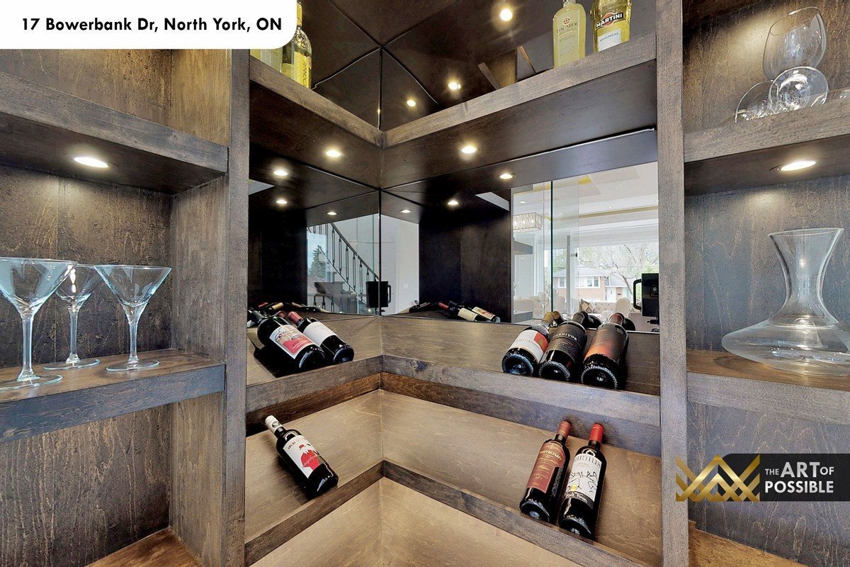 Interior of the walnut bar cabinet with mirrored back panel and wine bottle display