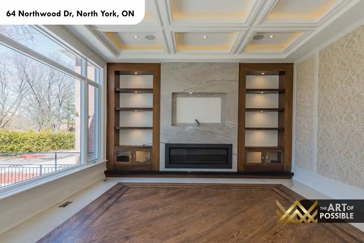 Family room walnut built-in shelving flanking marble fireplace