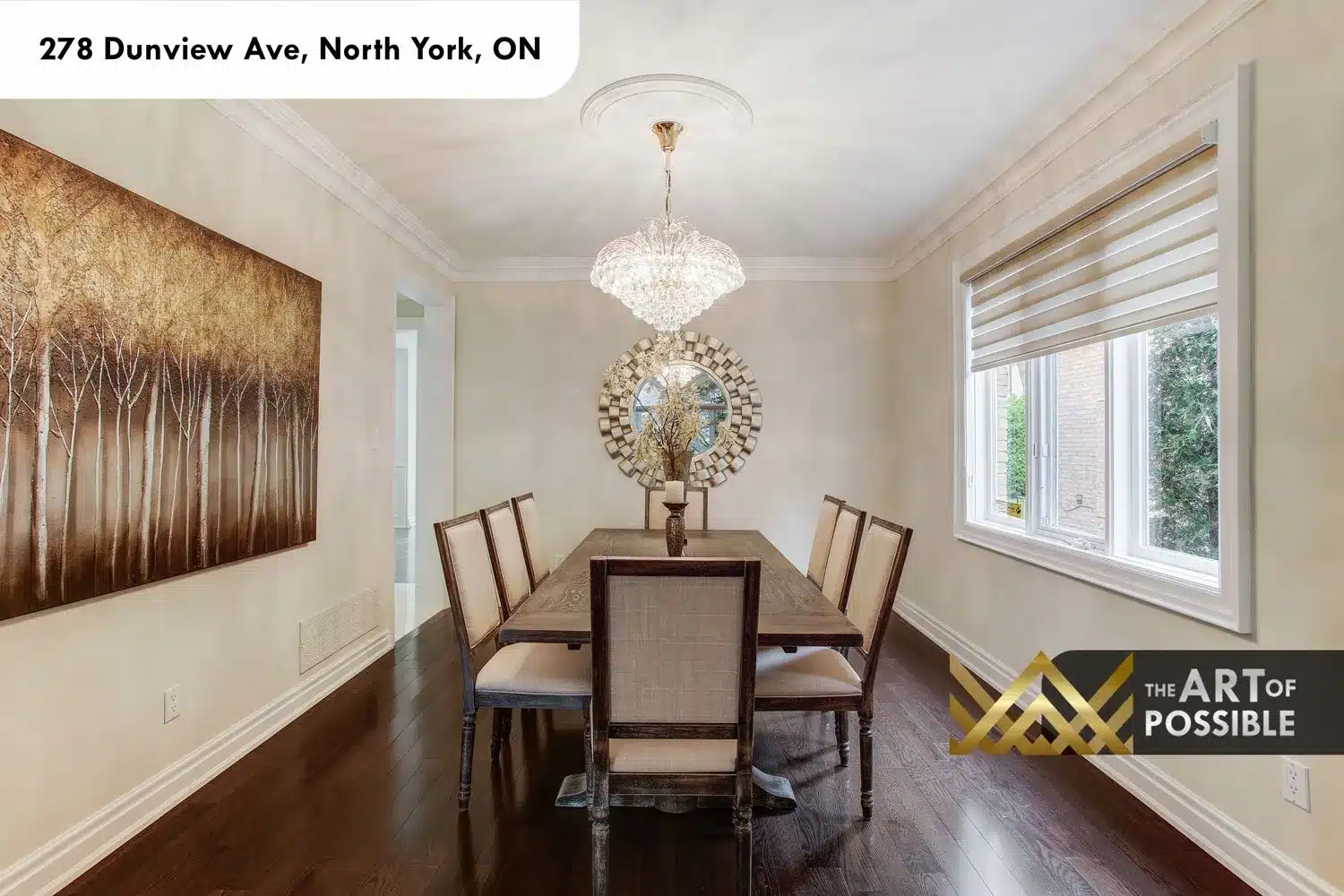 Formal dining room, crystal chandelier with gold hardware, dark hardwood floors, crown moulding