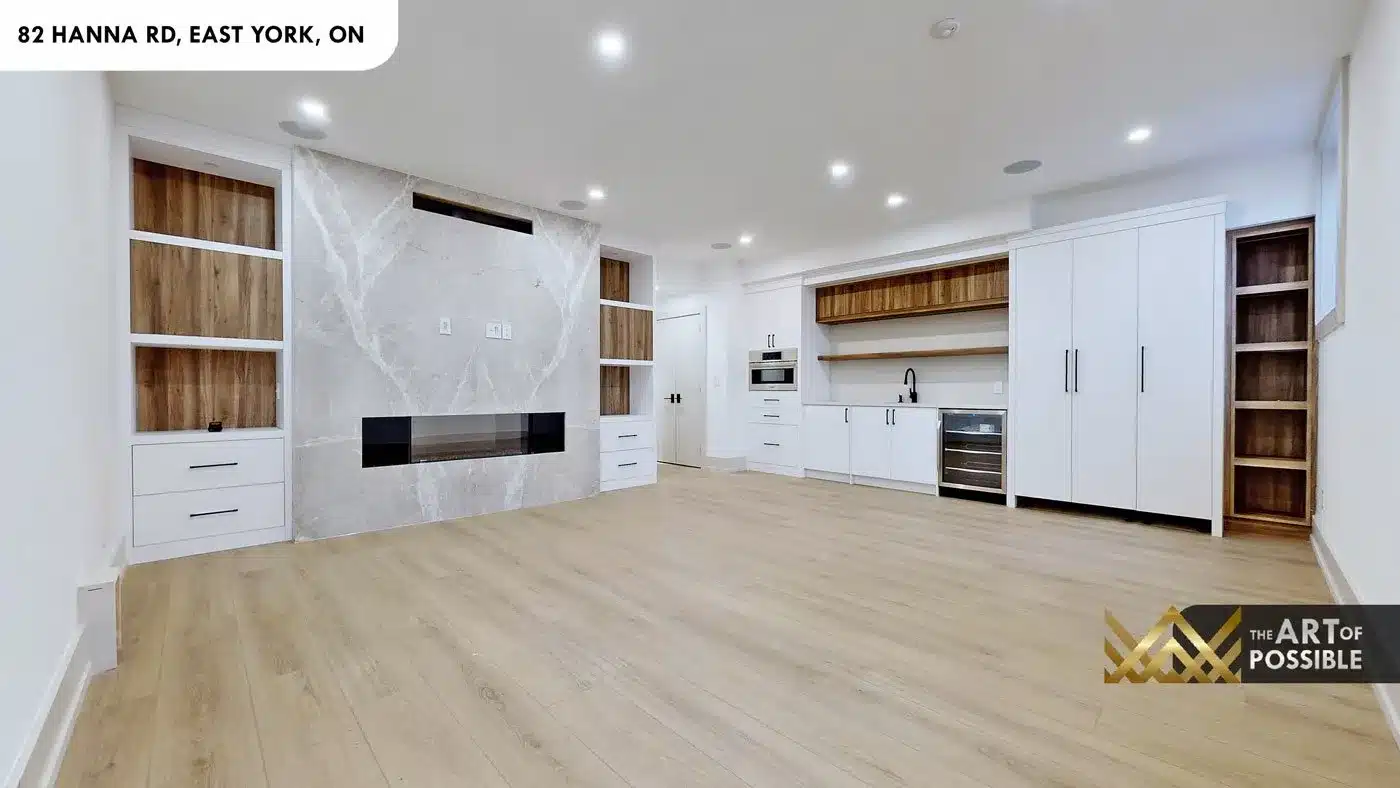 Basement recreation room with full-height marble fireplace wall and walnut built-ins at 82 Hanna Rd