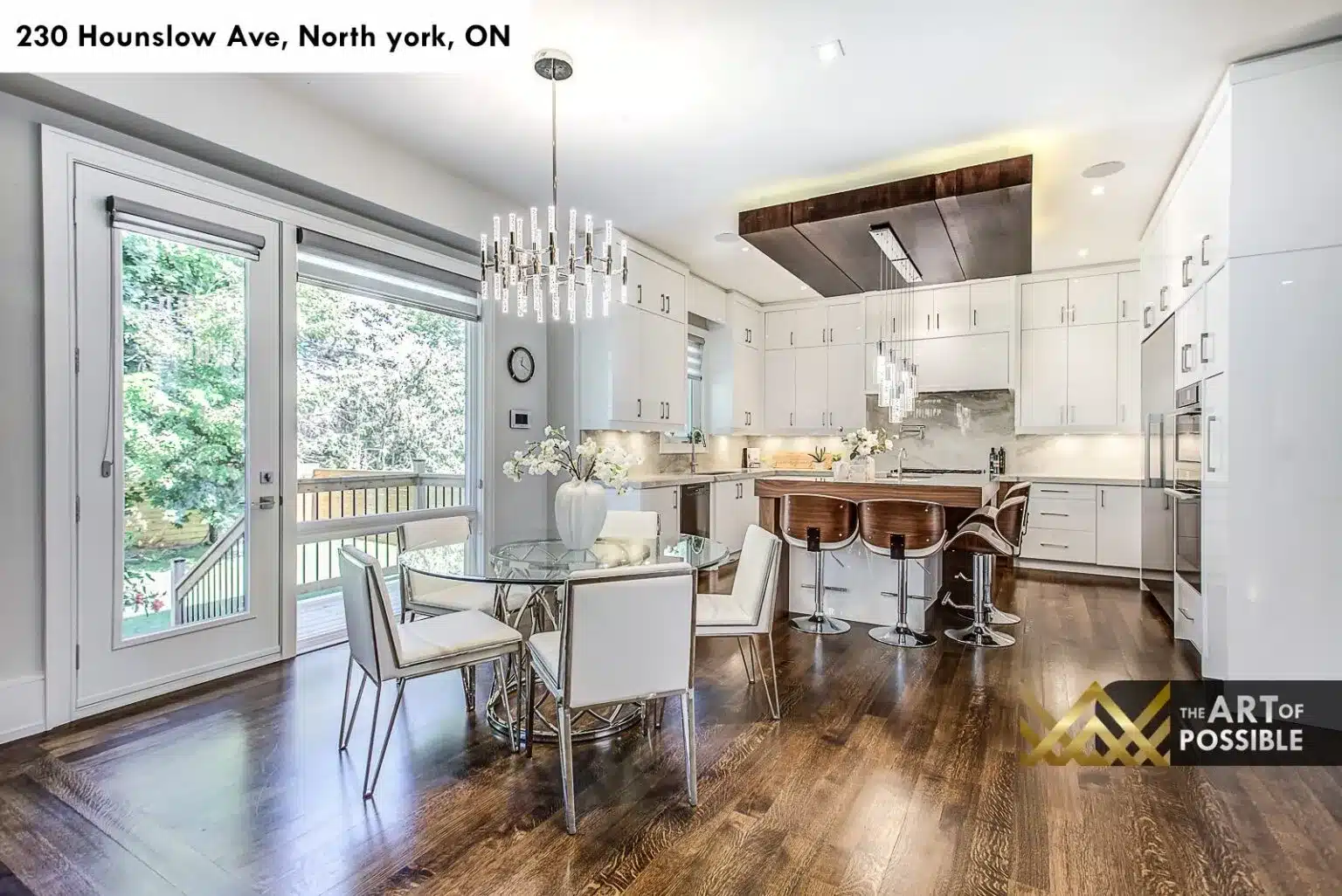 Breakfast nook and dining area adjacent to kitchen with chrome chandelier