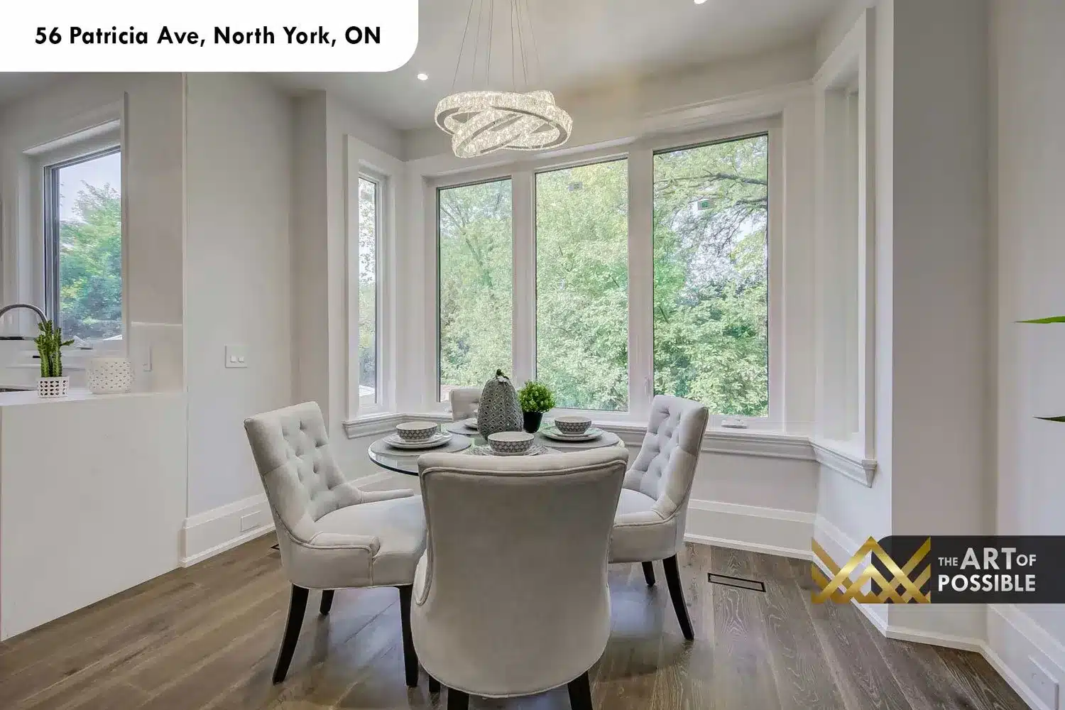 Breakfast nook at 56 Patricia Ave with crystal hoop chandelier and picture windows