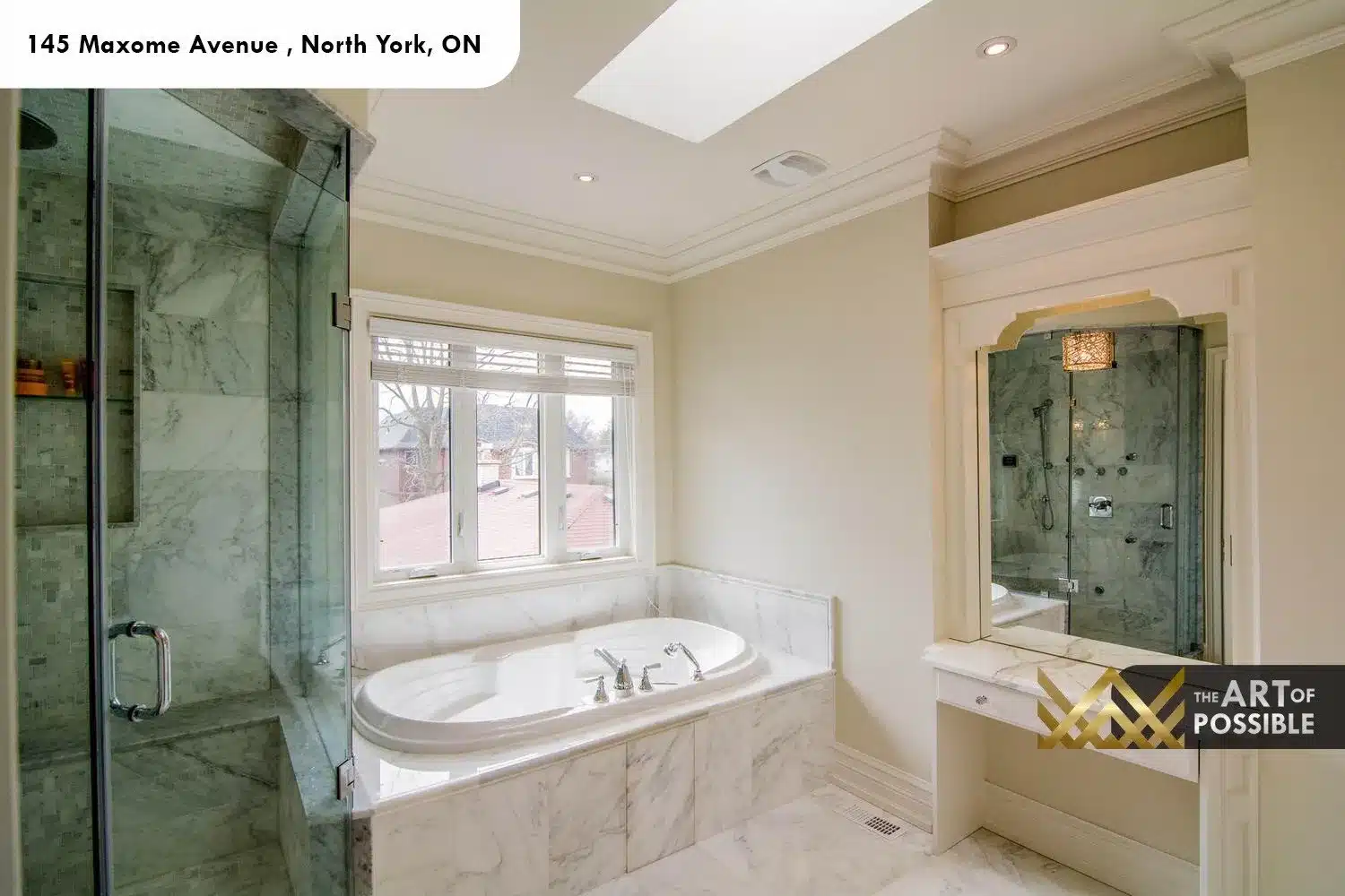 145 Maxome Avenue primary ensuite marble soaker tub glass shower skylight