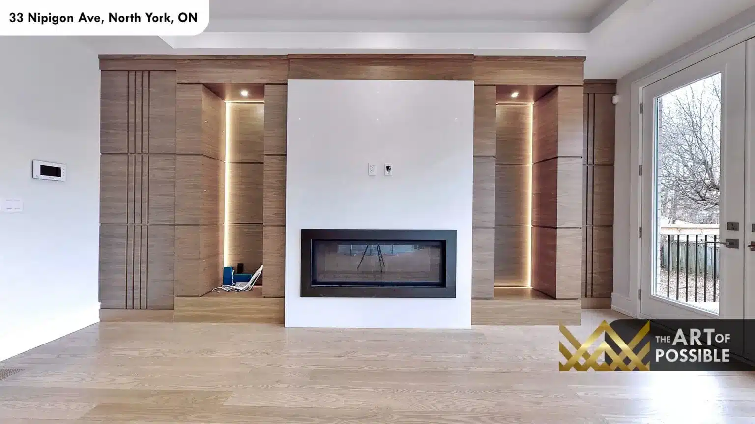 Walnut feature wall fireplace with backlit niche built-ins