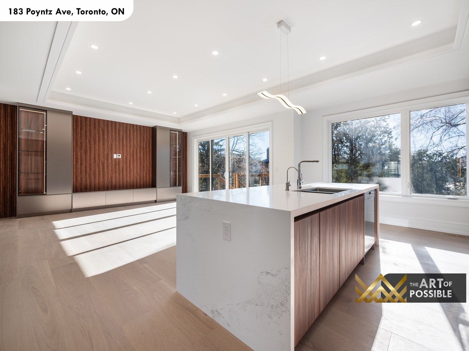 183 Poyntz Ave North York open plan kitchen and family room with walnut slatted wall and wave pendant light above island